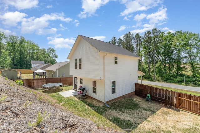 658 Morgan Rd, Albemarle, NC 28001 - view of property exterior featuring a trampoline, an outbuilding, a patio area, a fenced backyard, and a storage unit