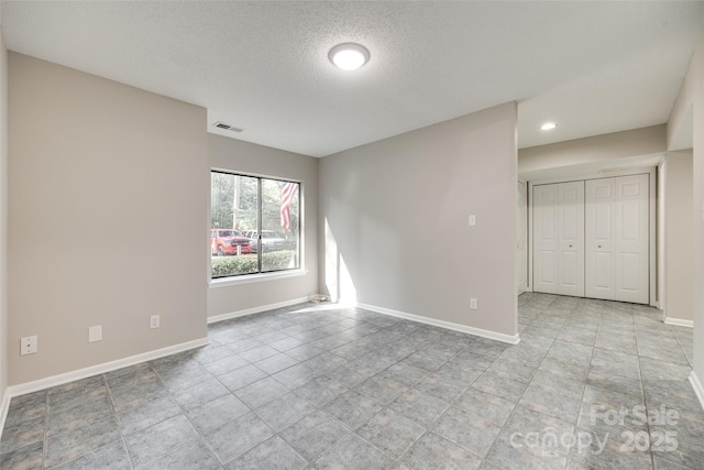 173 Greenridge Rd, Lake Wylie, SC 29710 - tiled spare room featuring baseboards, a textured ceiling, and recessed lighting