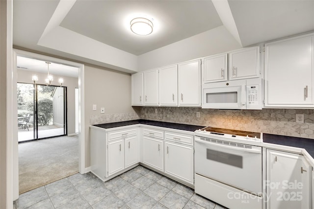173 Greenridge Rd, Lake Wylie, SC 29710 - kitchen with white appliances, dark countertops, light carpet, white cabinets, and backsplash