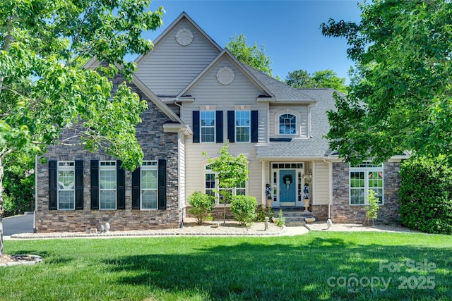view of front of house featuring a front lawn and stone siding