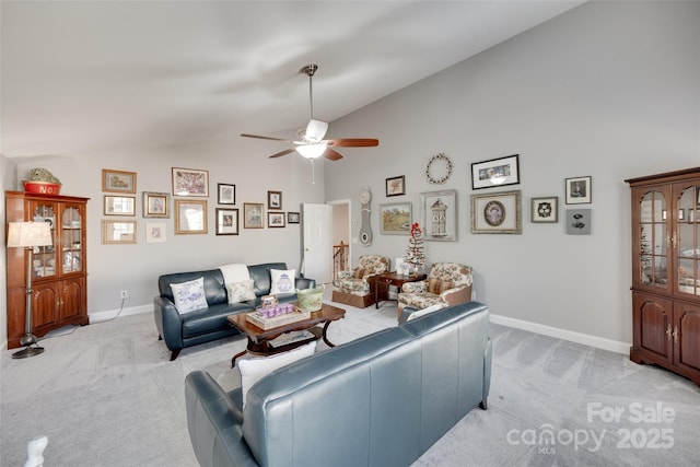 living area with baseboards, ceiling fan, light carpet, and high vaulted ceiling