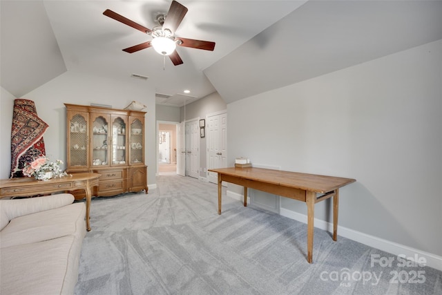 interior space featuring ceiling fan, visible vents, light colored carpet, vaulted ceiling, and baseboards