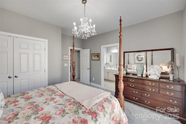 bedroom with connected bathroom, an inviting chandelier, carpet, baseboards, and a closet