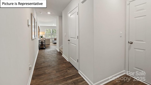 hallway featuring recessed lighting, dark wood-style flooring, and baseboards