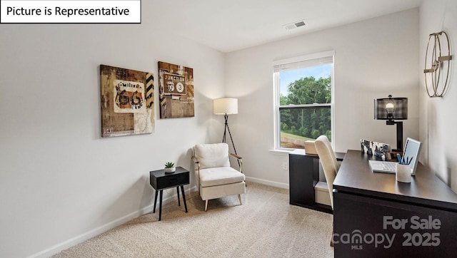 office featuring baseboards, visible vents, and light colored carpet