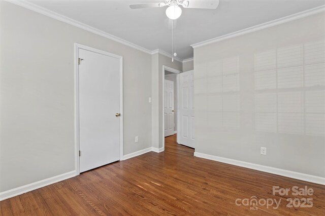 unfurnished bedroom featuring baseboards, a ceiling fan, crown molding, and wood finished floors