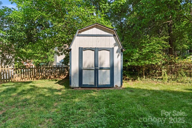 view of shed featuring fence