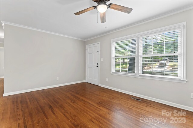 unfurnished room featuring visible vents, ornamental molding, wood finished floors, baseboards, and a ceiling fan