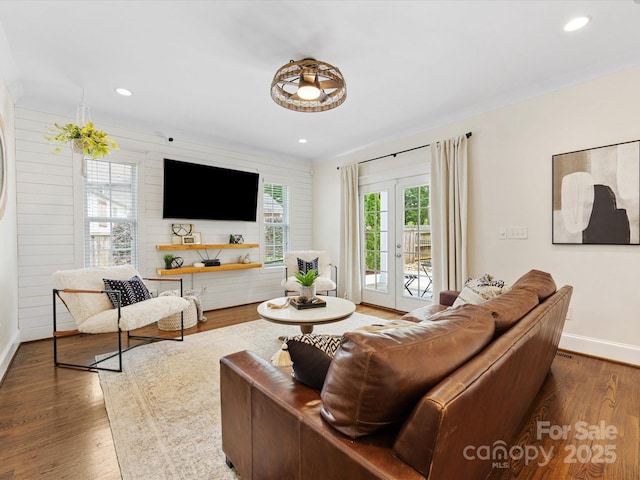 living area with baseboards, recessed lighting, and wood finished floors