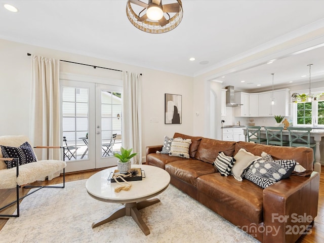 living area featuring recessed lighting, wood finished floors, and french doors