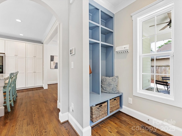 mudroom featuring dark wood-style flooring, baseboards, recessed lighting, and arched walkways