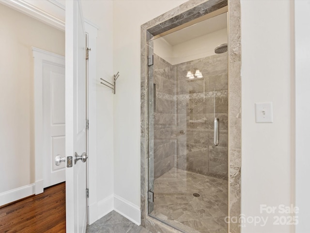 full bathroom featuring baseboards and a stall shower