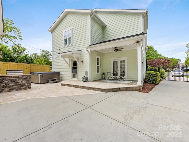 back of house featuring a patio area, ceiling fan, a hot tub, french doors, and fence