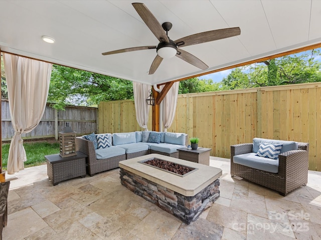 view of patio / terrace with an outdoor living space with a fire pit, a ceiling fan, and a fenced backyard