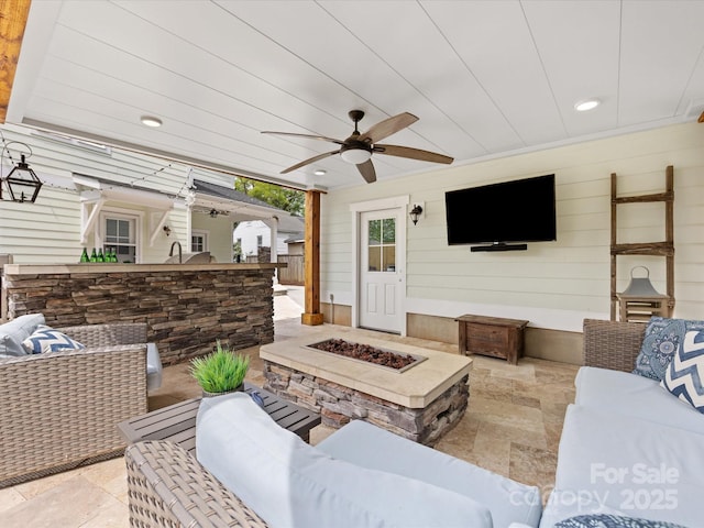 living area with recessed lighting, ceiling fan, wooden walls, and stone finish floor