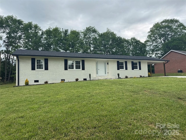 ranch-style house with a carport, a front lawn, brick siding, and crawl space