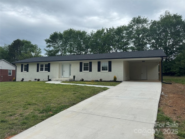 ranch-style house featuring concrete driveway, brick siding, a front yard, and a carport
