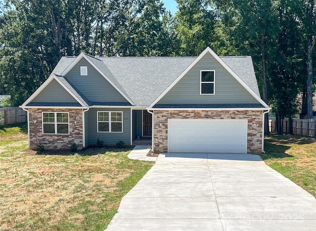 view of front of property featuring stone siding, concrete driveway, and a shingled roof