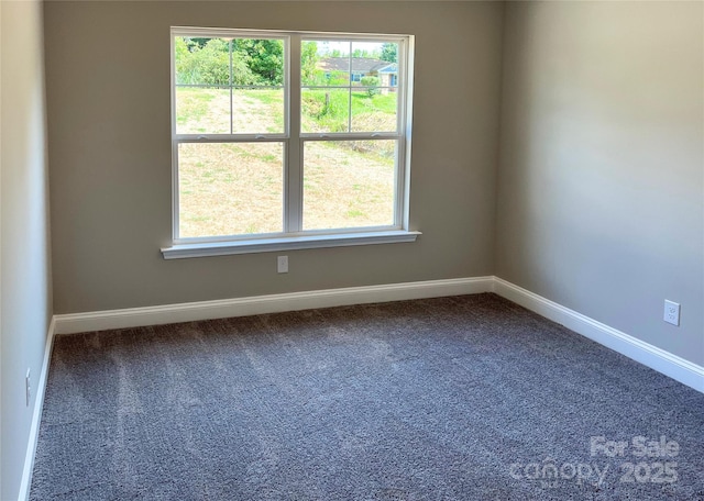 unfurnished room featuring carpet floors, plenty of natural light, and baseboards