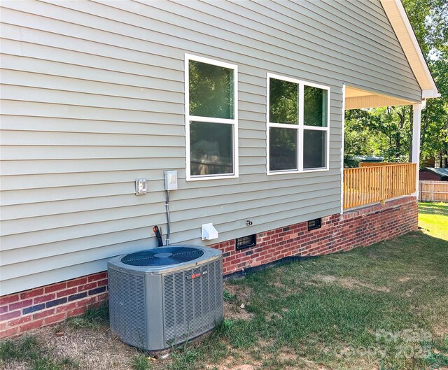 exterior view of crawl space and central air condition unit