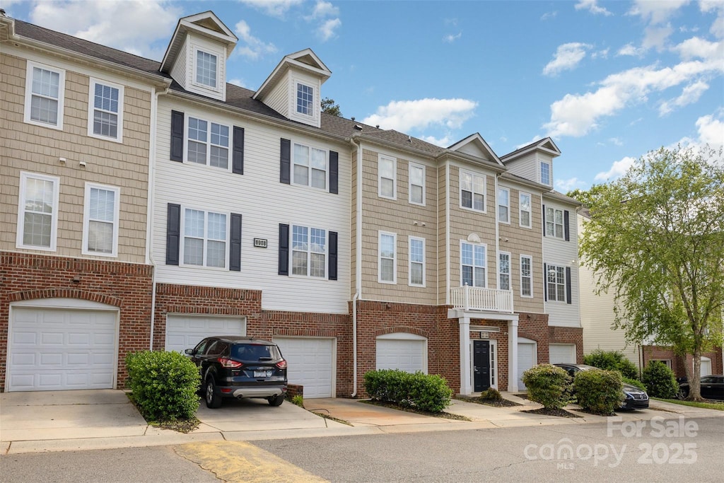 6912 Park Place Dr, Charlotte, NC 28262 - townhome / multi-family property with an attached garage, brick siding, and driveway