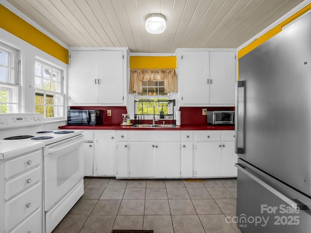 kitchen with light tile patterned flooring, stainless steel fridge, wood ceiling, a sink, and white electric stove