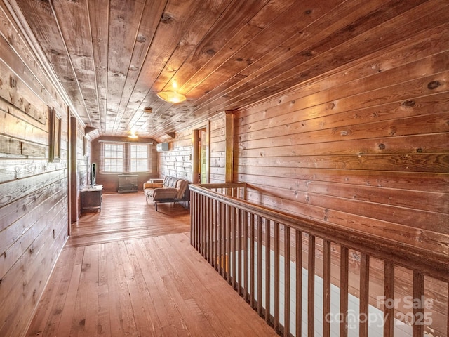 corridor with wooden ceiling, wood walls, and hardwood / wood-style floors