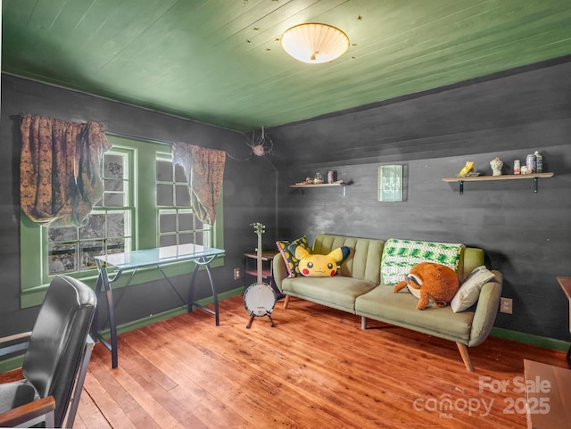 interior space with baseboards, hardwood / wood-style flooring, and wooden ceiling
