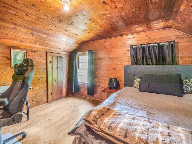 bedroom with wood ceiling, hardwood / wood-style flooring, wood walls, and lofted ceiling