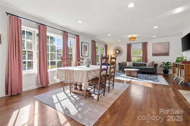dining area featuring baseboards, recessed lighting, plenty of natural light, and wood finished floors