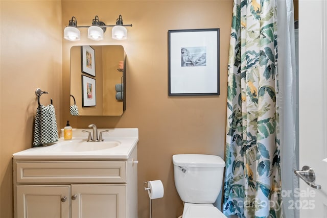 bathroom featuring vanity, a shower with curtain, and toilet