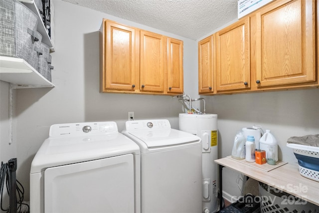 laundry area featuring a textured ceiling, cabinet space, washer and dryer, and electric water heater