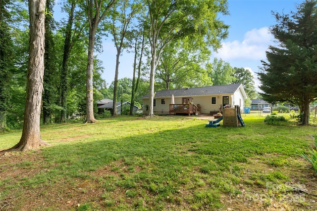 view of yard featuring fence and a wooden deck