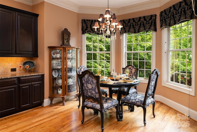 135 Sumter Dr, Mooresville, NC 28117 - dining space with crown molding, baseboards, a chandelier, and light wood-style flooring