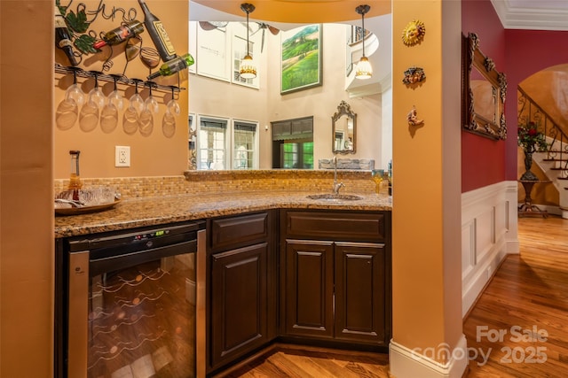 135 Sumter Dr, Mooresville, NC 28117 - bar featuring wine cooler, wood finished floors, indoor wet bar, a wainscoted wall, and a sink