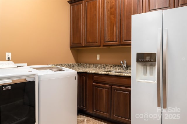 135 Sumter Dr, Mooresville, NC 28117 - laundry room featuring a sink, cabinet space, light tile patterned flooring, and washer and clothes dryer