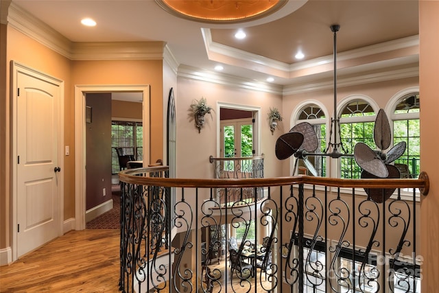 135 Sumter Dr, Mooresville, NC 28117 - hall with crown molding, wood finished floors, baseboards, a tray ceiling, and an upstairs landing