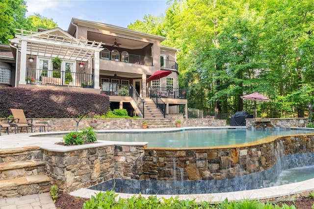 135 Sumter Dr, Mooresville, NC 28117 - back of property featuring ceiling fan, an infinity pool, a balcony, a pergola, and stairs