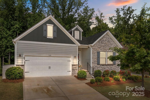 7620 Porrera St, Charlotte, NC 28214 - view of front of house with a garage, board and batten siding, stone siding, and concrete driveway
