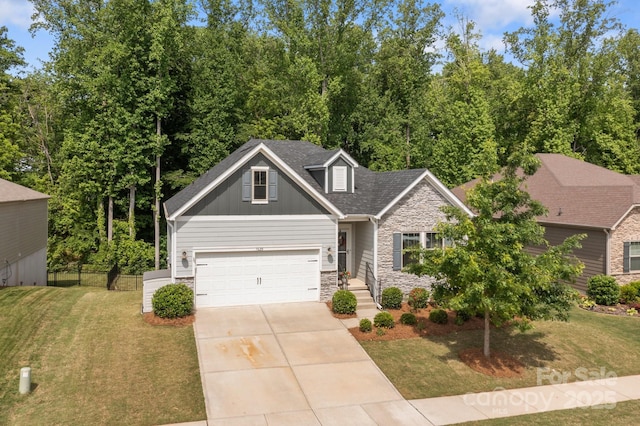 7620 Porrera St, Charlotte, NC 28214 - craftsman house featuring fence, a front lawn, stone siding, board and batten siding, and driveway