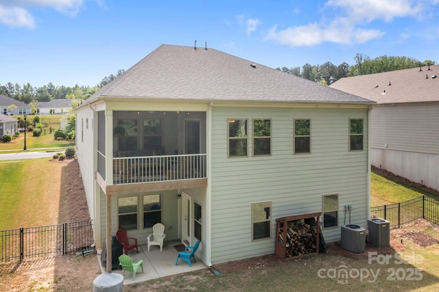 7620 Porrera St, Charlotte, NC 28214 - rear view of house with fence, a patio, a shingled roof, and a sunroom