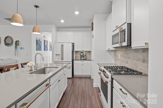 7620 Porrera St, Charlotte, NC 28214 - kitchen featuring white cabinets, dark wood-style floors, a sink, white appliances, and pendant lighting