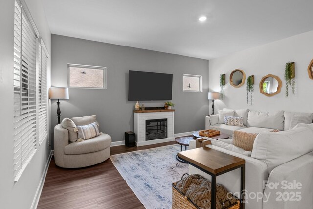 7620 Porrera St, Charlotte, NC 28214 - living room with baseboards, recessed lighting, a glass covered fireplace, and wood finished floors