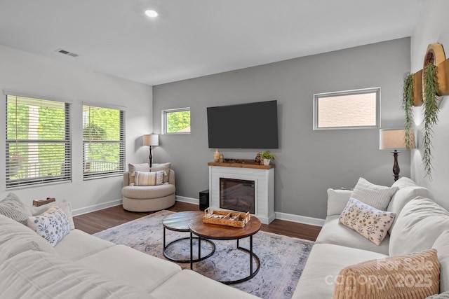 7620 Porrera St, Charlotte, NC 28214 - living room with baseboards, a fireplace, wood finished floors, and visible vents