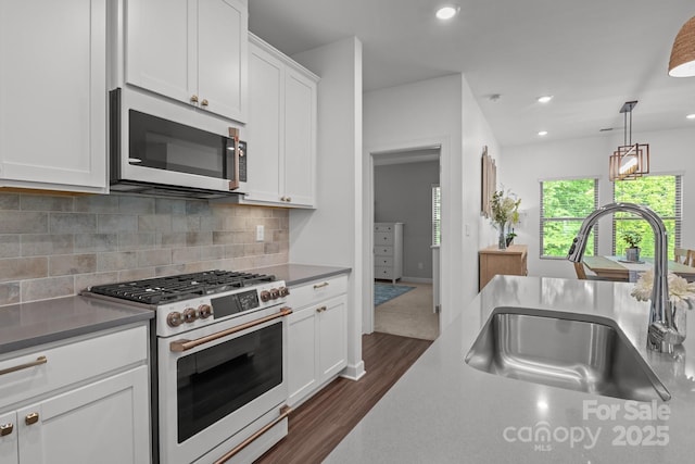 7620 Porrera St, Charlotte, NC 28214 - kitchen with a sink, high end range, white cabinetry, decorative backsplash, and dark wood-style floors