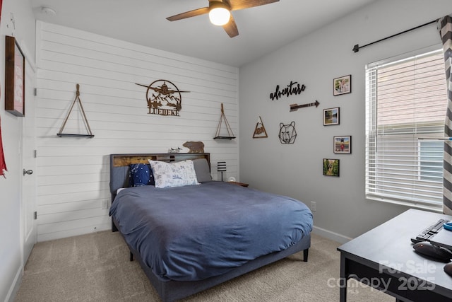 7620 Porrera St, Charlotte, NC 28214 - carpeted bedroom featuring wooden walls, baseboards, and a ceiling fan