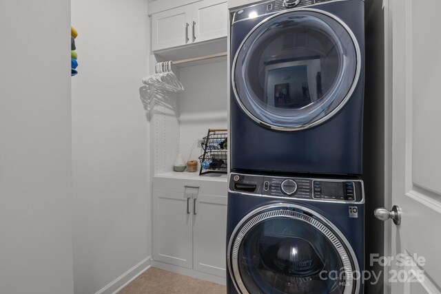 7620 Porrera St, Charlotte, NC 28214 - clothes washing area featuring cabinet space and stacked washer / drying machine
