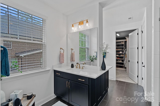 7730 Burning Ridge Dr, Stanley, NC 28164 - bathroom featuring vanity, baseboards, and a spacious closet