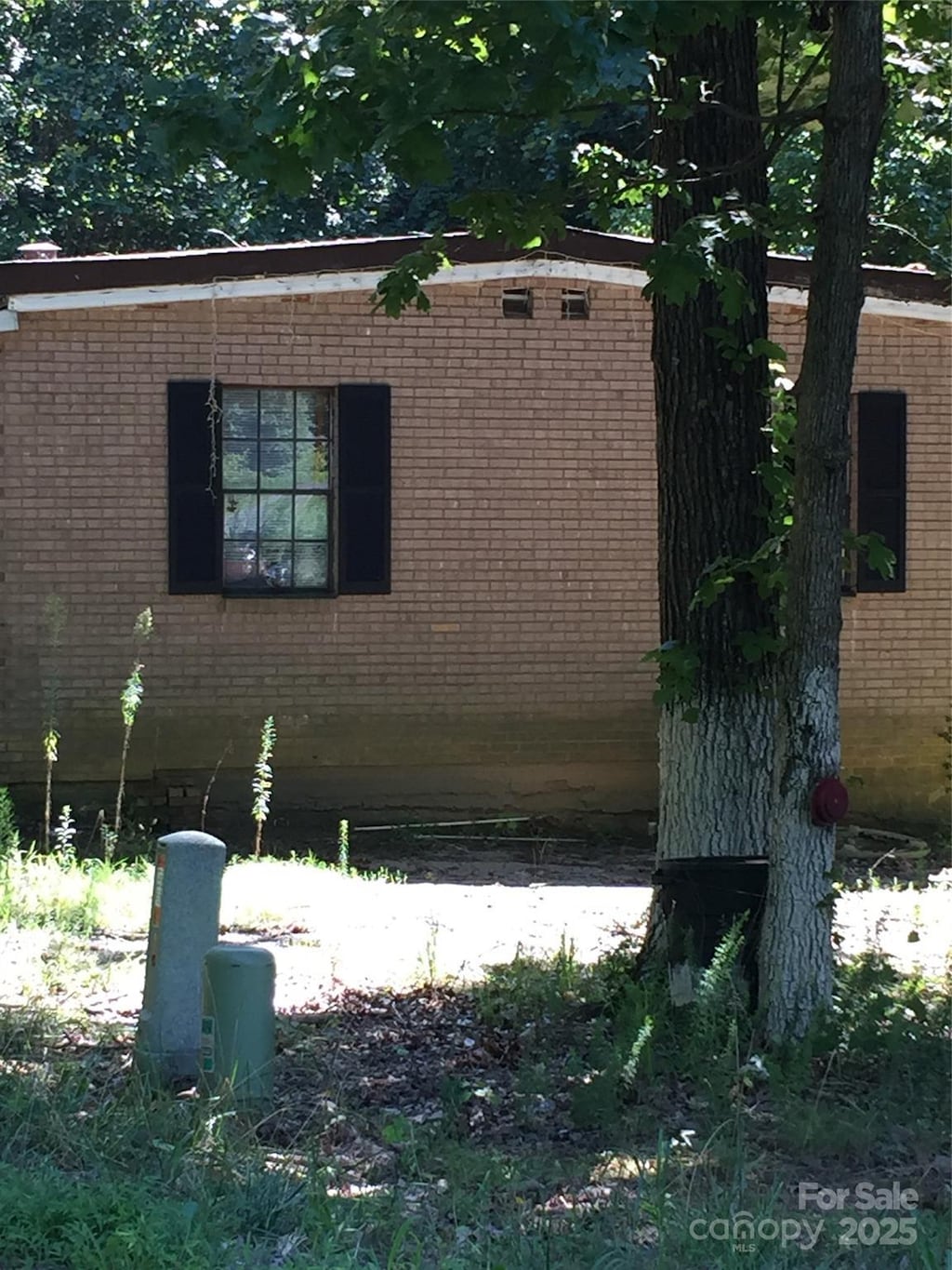 view of side of home with brick siding