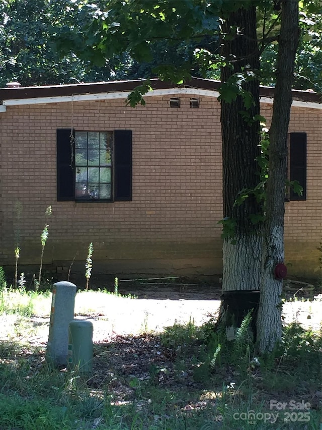 view of side of home with brick siding